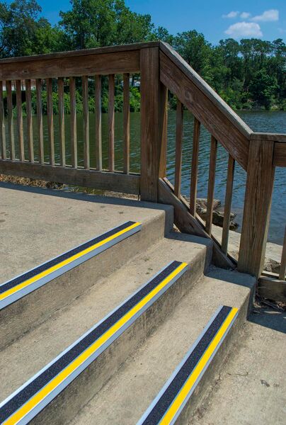 bold step 3 Floormat.com <h4><strong>This item is sold by the foot. Be sure to order enough for your project.</strong></h4> Slip-resistant treads for indoor or outdoor staircases <ul> <li>sold by the foot</li> <li>specialized coating helps our stair treads to resist chips, dirt, scratches, stains and oil.</li> <li>stair treads can be used on exterior and interior flooring surfaces</li> <li>Our treads can be customized to complement the existing architecture of any building.</li> </ul> <h2>Bold Step Anti-slip Safety Renovation Treads</h2> These stair treads and nosings are an eye-catching, resilient, slip-resistant product for use on steps that require an anti-slip surface. Used in new construction or renovation projects, our treads and nosings deliver maximum safety and durability while providing a look to compliment building designs. Bold Step is strong enough for industrial applications, but attractive enough to be used at your residence. Designed for use on interior or exterior steps and landings, the treads feature an anti-slip coating system that resists chips, scratches, dirt, stains and oils Many Standard Colors Black • Gray • Yellow • White Red • Blue • Green • Brown Glow in the Dark and custom colors are available Ideal for use on wood steps, ramps, landings, and walkways. Also for use on concrete, steel, terrazzo, slate, and marble, inside or out! <b>Bold Step</b> Features: <ul> <li>Anti-slip safety surface</li> <li>No removal of existing stairs</li> <li>Visibility line safety contrast</li> <li>Easily cleaned</li> <li>Quick, simple installation</li> <li>Reasonable cost</li> <li>Long life durability</li> <li>Inside or outside use</li> <li>Aesthetically pleasing design</li> <li>All treads are pre-drilled with countersunk holes</li> <li>Fasteners available</li> <li>Custom miter cut-outs</li> </ul> <form action="https://www.aitsafe.com/cf/addmulti.cfm" method="post"> <p class="pthdr"><b>Master Stop Bold Step Anti-Slip Renovation Treads from Sure-Foot Industries</b> Offered in standard and custom colors in lengths up to 12 ft., price below covers standard two color treads</p> <h4><strong>This item is sold by the foot. Be sure to order enough for your project.</strong></h4> </form>