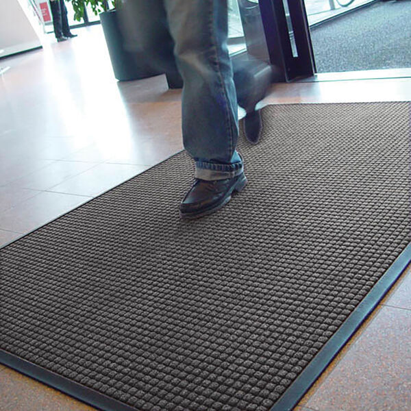 guzzler 4 Floormat.com Guzzler™ is intended for use in medium to heavy traffic areas, the raised, crushproof waffle design of Guzzler™ aggressively scrapes and cleans, while the rubber-edged perimeter entraps dirt and moisture for superior water and soil control. Molded rubber “cleats” on the underside of the mat grip the underlying surface minimizing mat movement. <ul> <li>High/low waffle pattern facilitates scraping and keeps moisture and debris away from foot traffic</li> <li>Raised rubber border on all 4 sides traps moisture and debris for easy removal</li> <li>Molded rubber cleats on the bottom of the mat grip underlying surfaces and minimize mat movement</li> <li>26 ounces of tufted yarn per square yard</li> <li>3/8 inch overall thickness for use in narrow clearance doorways</li> </ul>